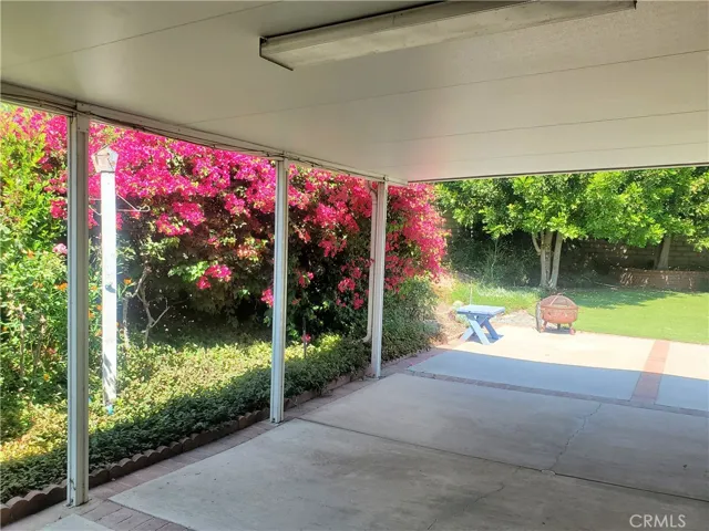 Side yard area with large covered patio