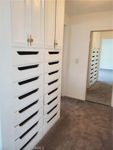 Primary bedroom with built-in drawers & cabinets.
