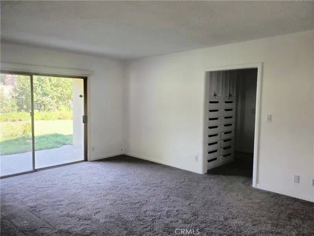 Primary bedroom with a covered patio & a slider to the backyard