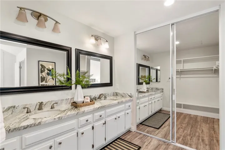 So much space here with a dual vanity and stone countertop!