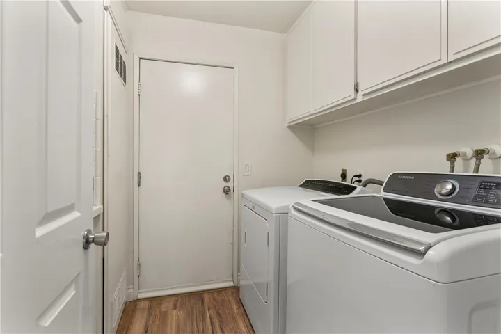 An indoor laundry room with convenient direct garage access.