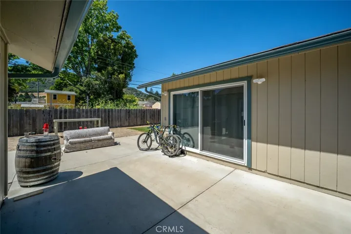 Back patio facing sliding glass door to primary bedroom