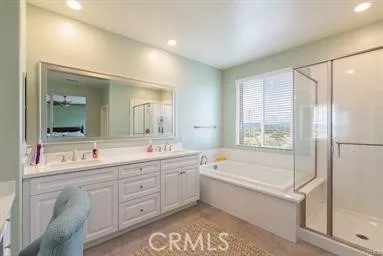 Dual sink, separate soaking tub, and walk-in closet