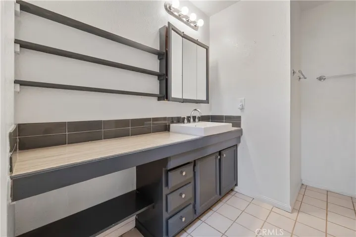 This en suite bath has a large vanity and plenty of storage. The tub/shower combination in this room is perfect.