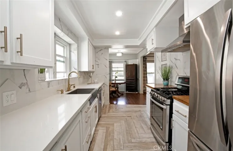 Kitchen has plenty of counter space and storage, farmhouse sink, stainless steel appliances