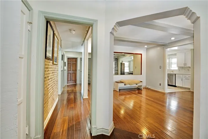 Foyer view of hallway leading to private bedrooms and spacious dining room