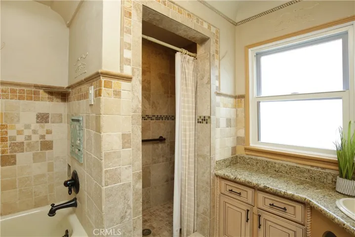 Roomy bathroom with both tub and separate shower enclosure