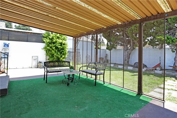 Covered patio can accomodate both sitting and dining area - perfect for alfresco dining.