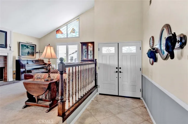 Double Door Entry to Tiled 2-Story Foyer, Soaring Ceilings, and Formal Living Room