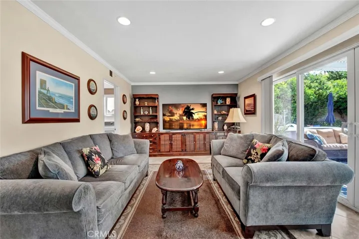 Family Room is Open to Kitchen and has Double Milgard Sliders that Open to Paradise Backyard
