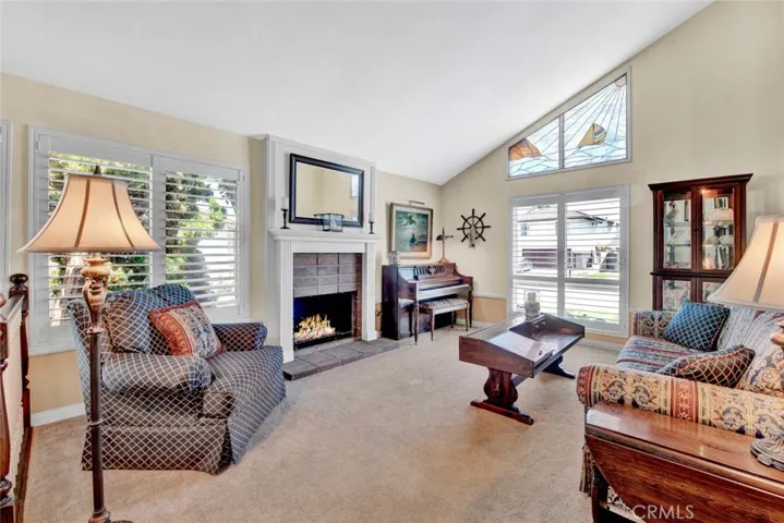 Elegant Formal Living Room with Vauled Ceiling, Fireplace with Custom Mantel & Surround, High Transom Leaded Glass Windows for Lots of Natural Light