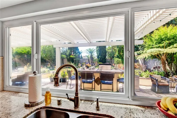 Stainless Sinks with Dual Pane Milgard Windows Overlooking Gorgeous Backyard