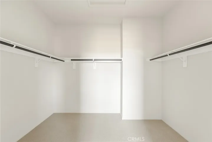 Extra large walk-in closet in primary bedroom.