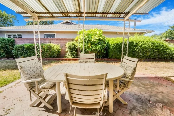 Step out of sliding glass doors to covered patio
