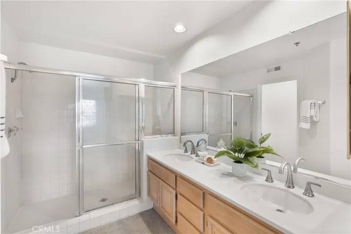 Primary bath with step in shower and double sinks.