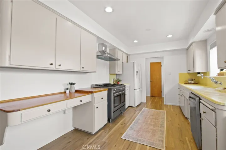 Modern appliances include a gas/electric range and stainless hood, microwave, dishwasher and refrigerator.