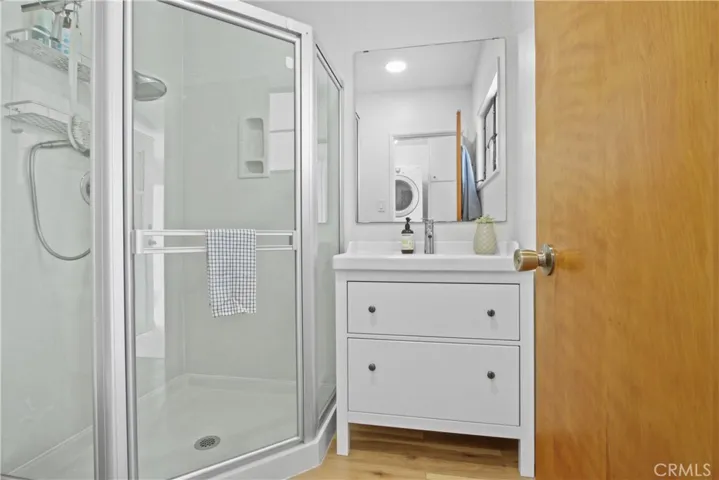 The hallway bathroom has an oversized shower.