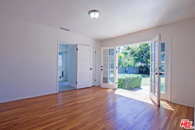 Den with French doors to large grassy yard