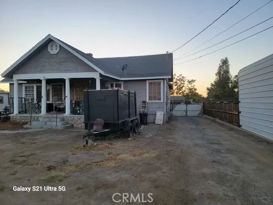 FRONT OF MAIN HOME PLUS SIDE ACCESS TO GARAGE/POOL AREA