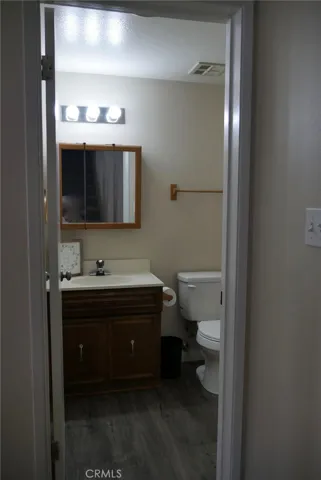 1st Floor 1/2 Bath: newer laminate flooring, upgraded fixtures, single sink & vanity, toilet, medicine cabinet, exhaust fan.