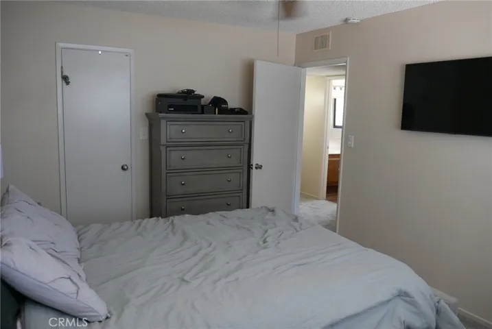 Primary Bedroom: opposite view, door to large walk-in closet at left rear.