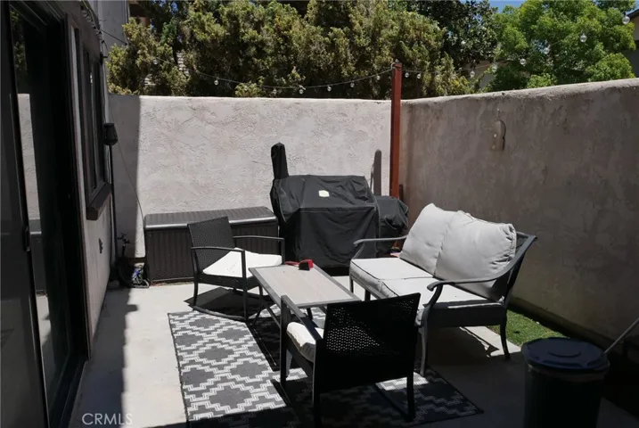 Patio: large size, fully enclosed, private, sliding door to living room, rock lined flowerbeds out of view.