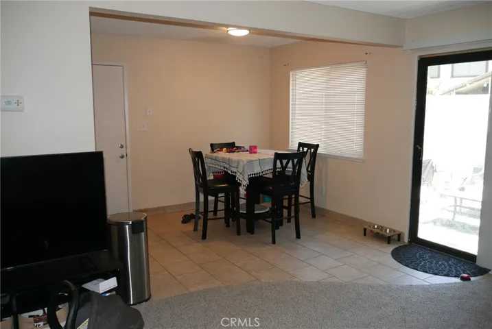 Dining Area: tile flooring. large window, light & bright, with patio view.