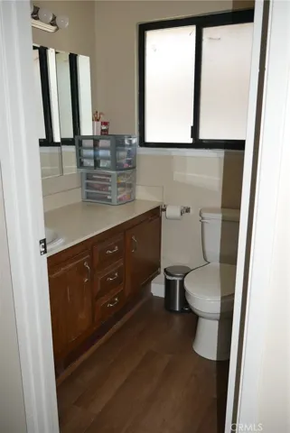 2nd Floor Full Bathroom: newer laminate flooring, upgraded fixtures, large window, single sink & large vanity, toilet, medicine cabinet, tub/shower combo, shower curtain.