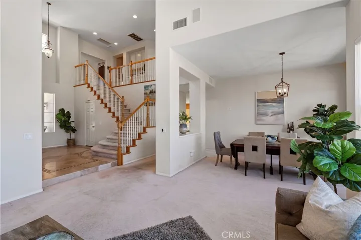 The living space is bathed in natural light with soaring ceilings.