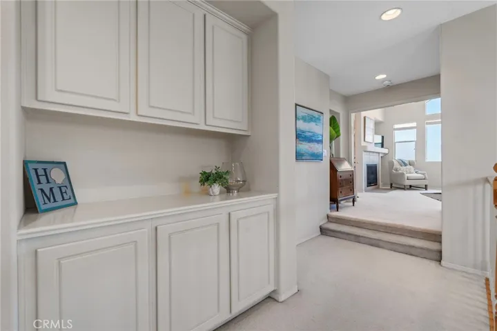 Spacious hallway features ample linen storage and convenient laundry chute.