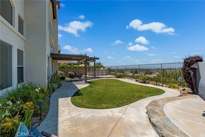 Backyard oasis with views, spa, BBQ, mature plum, lemon and magnolia trees.