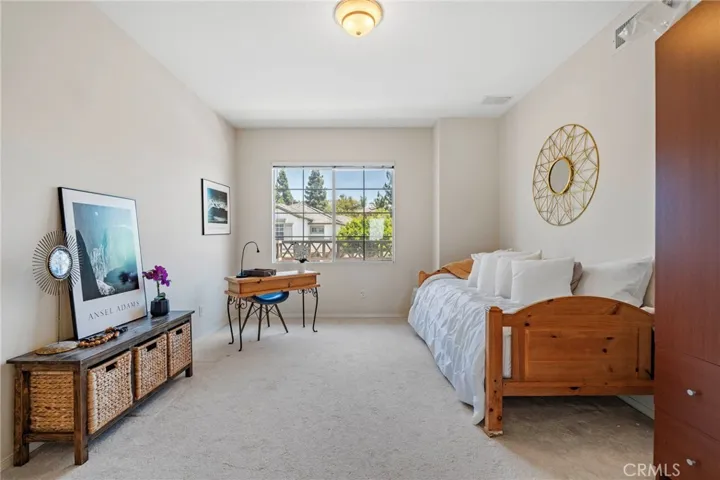 Upstairs bedroom is airy and bright with wardrobe.
