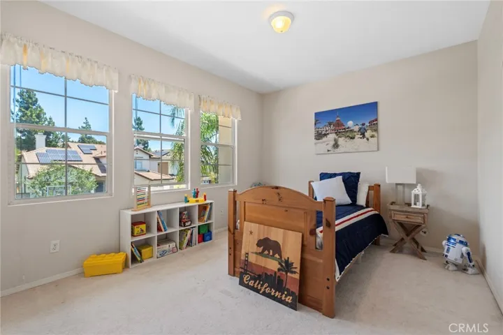 Upstairs bedroom with windows abound and closet.