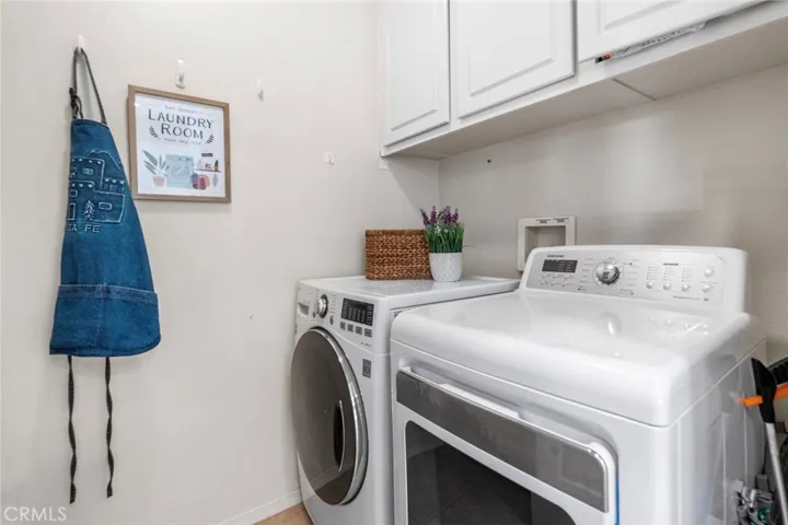 Laundry with sink and ample storage off kitchen.