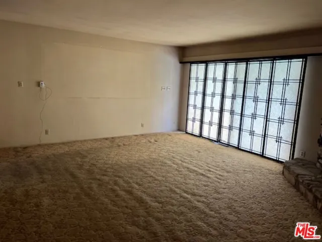 Living room with sliders out to pool and patio