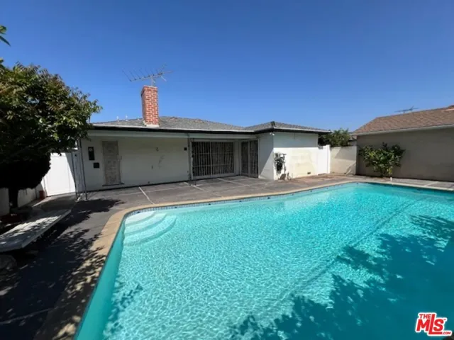 Sparking pool in back with covered patio area