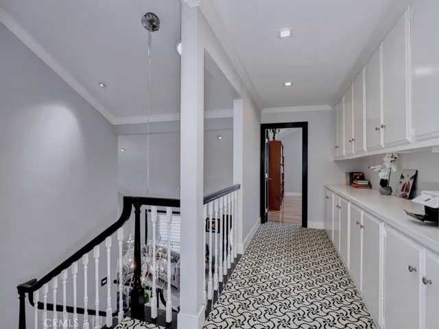 Large Upstairs hallway with many cabinets