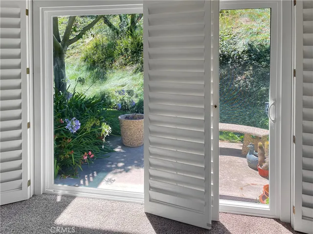Doors from primary lead to charming and private patio.
