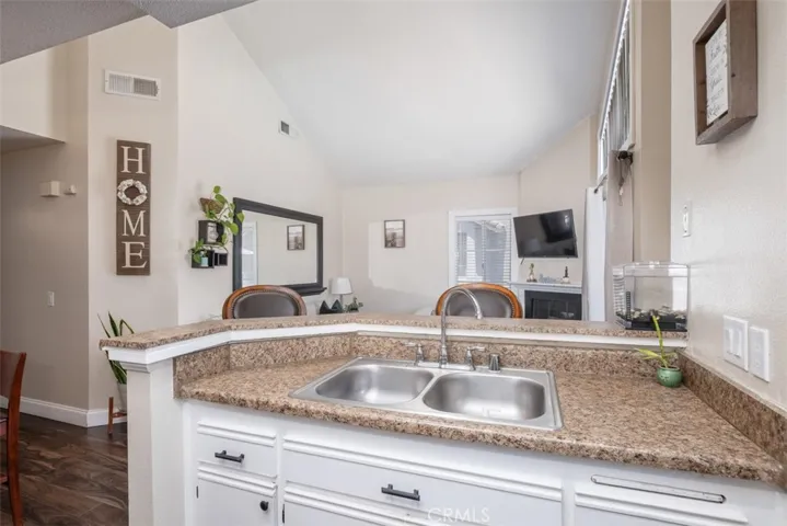 The kitchen overlooks the livcing room area as well