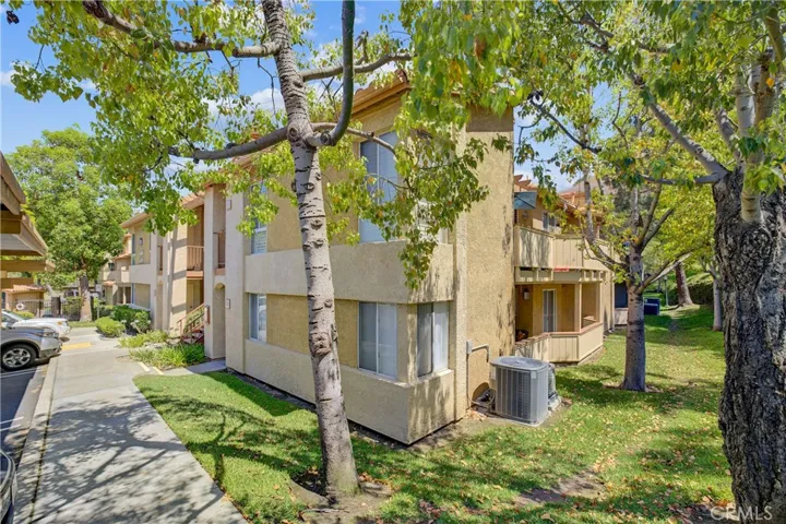 Balcony on the side of the condo shaded by trees