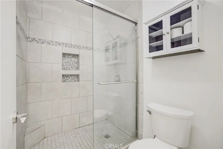 Tiled shower with glass enclosure