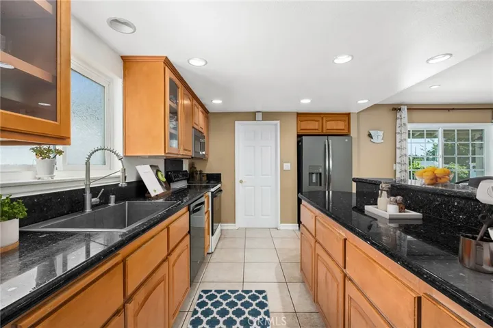 Kitchen with access to laundry room & direct access to garage.