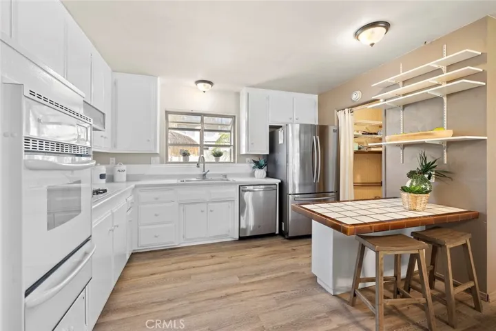 Laundry area and water heater adjacent to the kitchen has direct entrance into the garage.