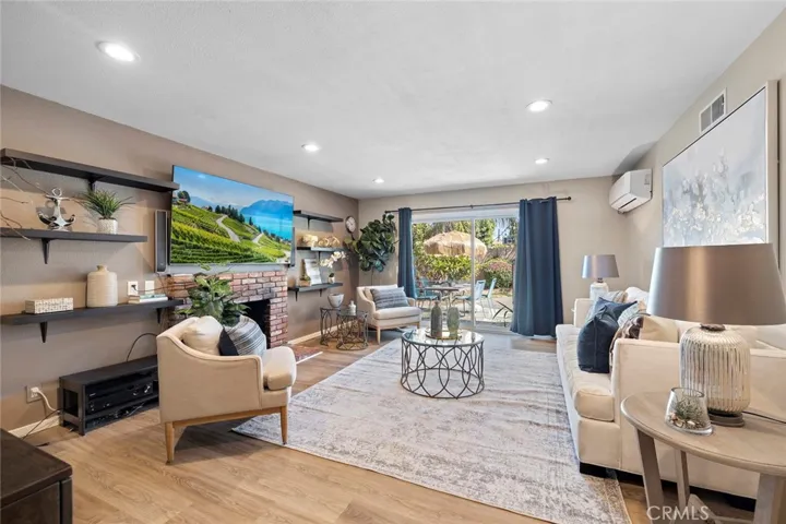 Living room with gas fireplace and sliding doors out to the pool area.