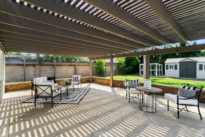A large covered shaded patio provides ample space for entertaining and relaxing...