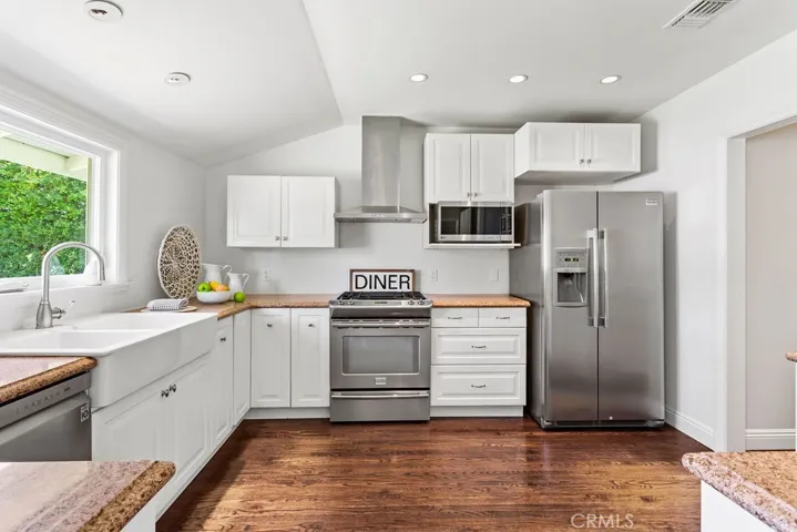 Kitchen with stainless appliances, farmhouse sink and tons of cabinets