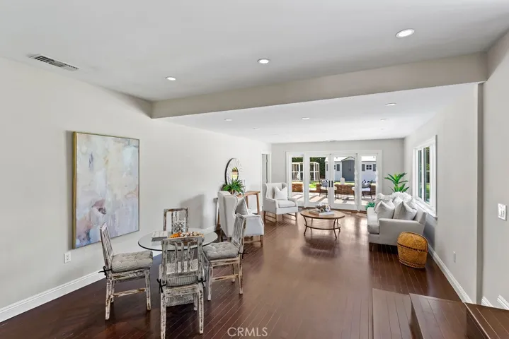 The spacious family room is the perfect gathering spot with access to a large patio and backyard...