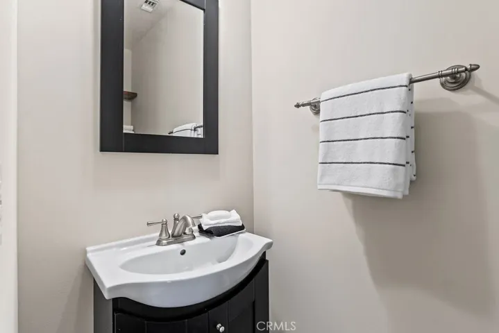 A powder room is located between the kitchen and family room