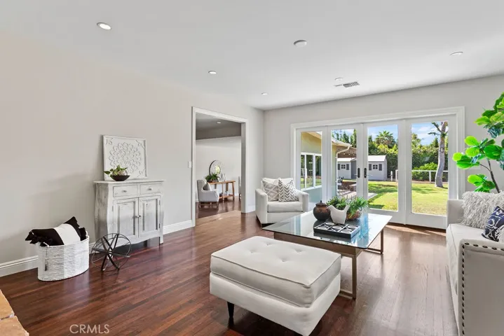 Featuring an inviting living room overlooking the spacious backyard...