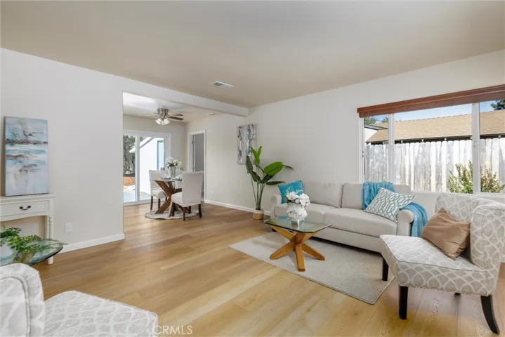 Wood-look vinyl floors flow from entrance through the main areas of the home